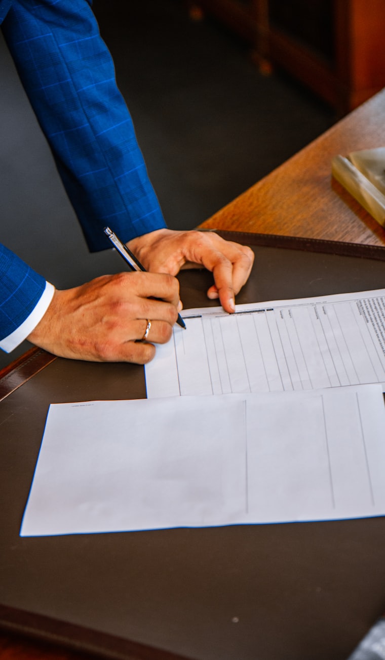 Signing a document at a desk